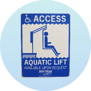 Accessible aquatic lift sign indicating availability upon request for individuals with disabilities. The sign features a blue and white design with an illustration of a person using the lift.