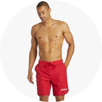 Man wearing red swim trunks with "GUARD" printed on the left leg. The swim trunks feature an adjustable drawstring waist and are ideal for lifeguards.