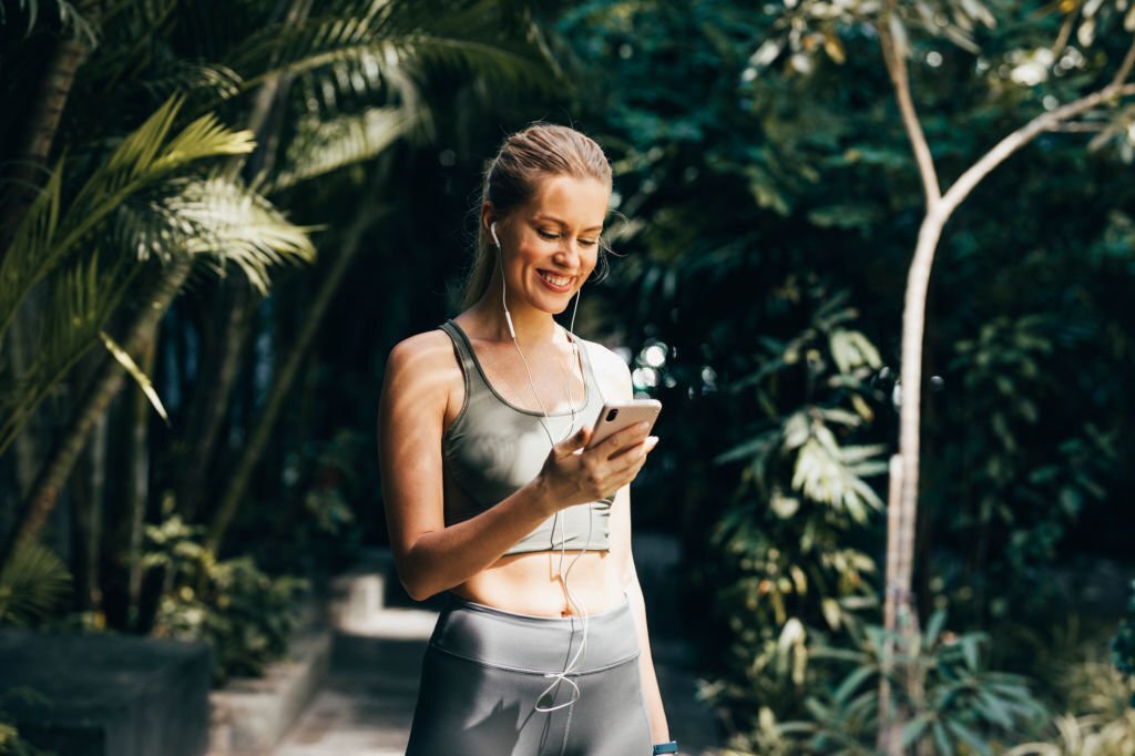 Woman motivated to play sports listening to music.jpg