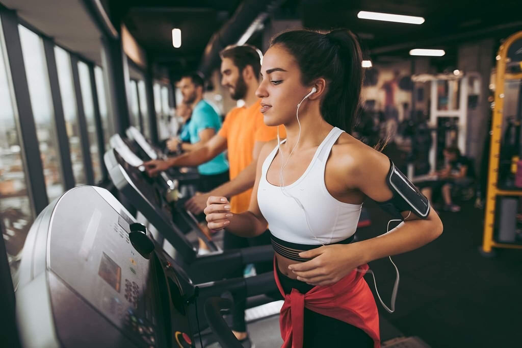 woman and men running on treadmill gym cardio method.jpg