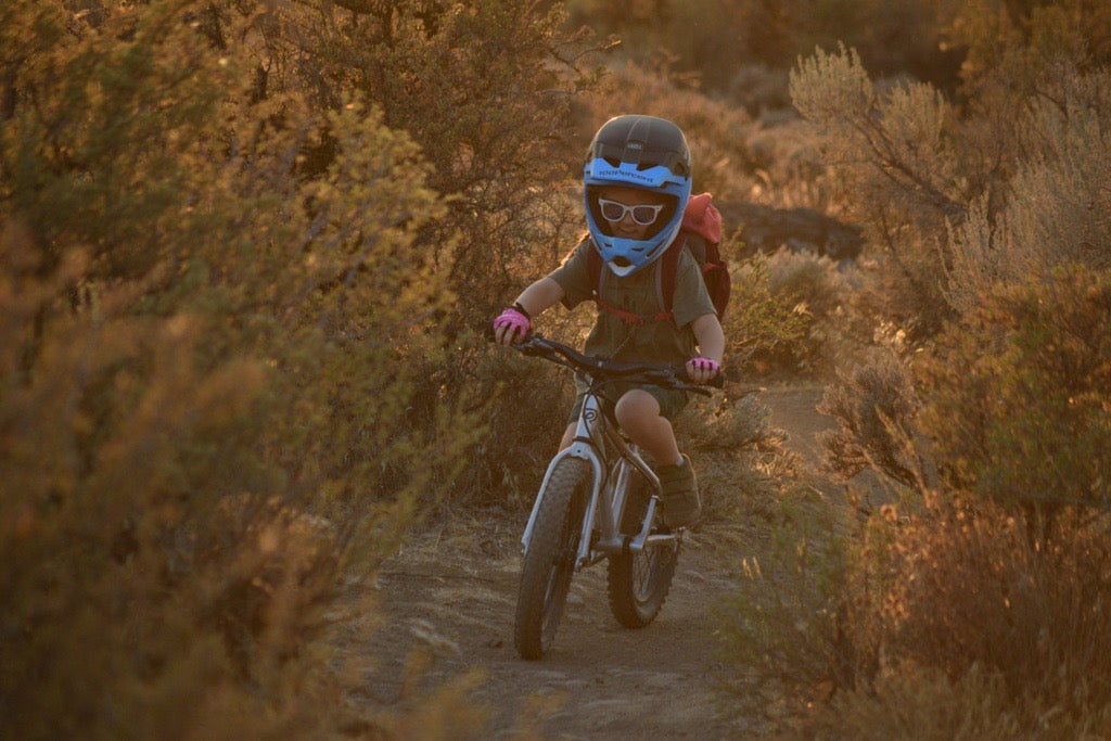 Girl riding down a dirt path 