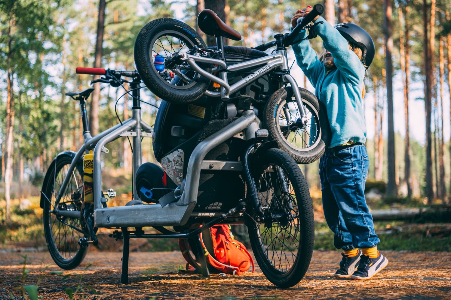 Kid lifting their bike off a bike rack