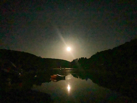 Boats in the moon light on the river fowey at Lerryn cornwall