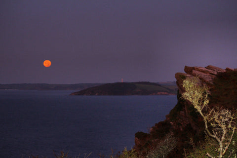 Harvest moon setting over st Austell bay cornwall