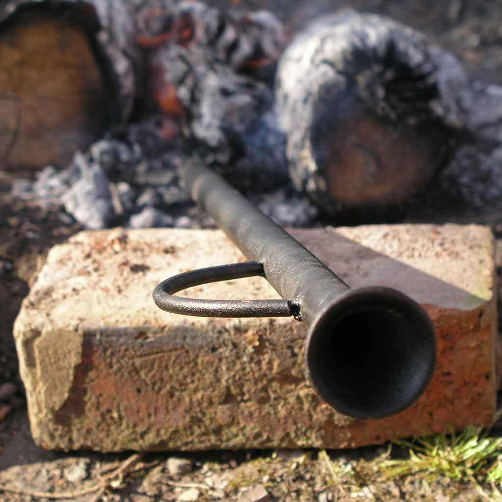 A bouffadou pipe rests on a log.