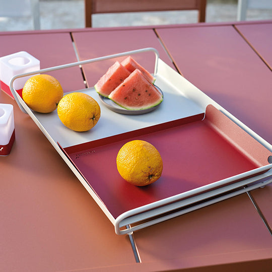 A tray on a table with fruit on top