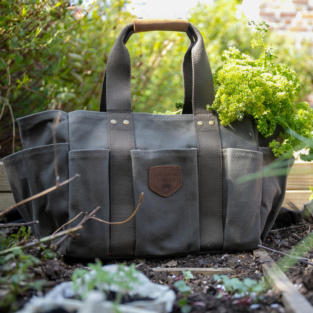 A waxed canvas bag rests on the ground