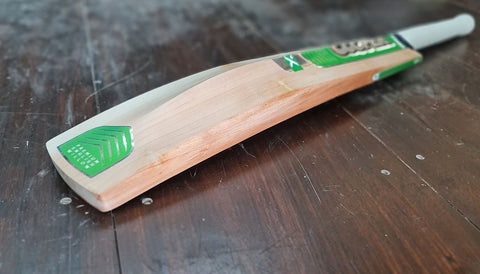 Cooper Cricket in the workshop Cooper MX custom cricket bat with green stickers