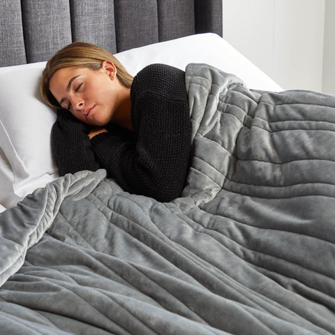 Woman sleeping in her very comfortable bed