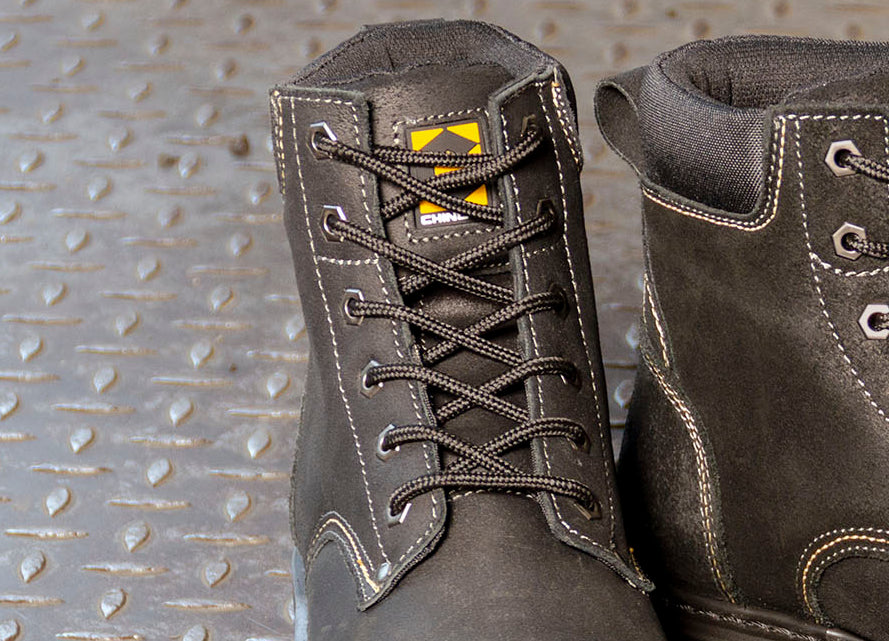 Chinook Rancher boots resting on logs