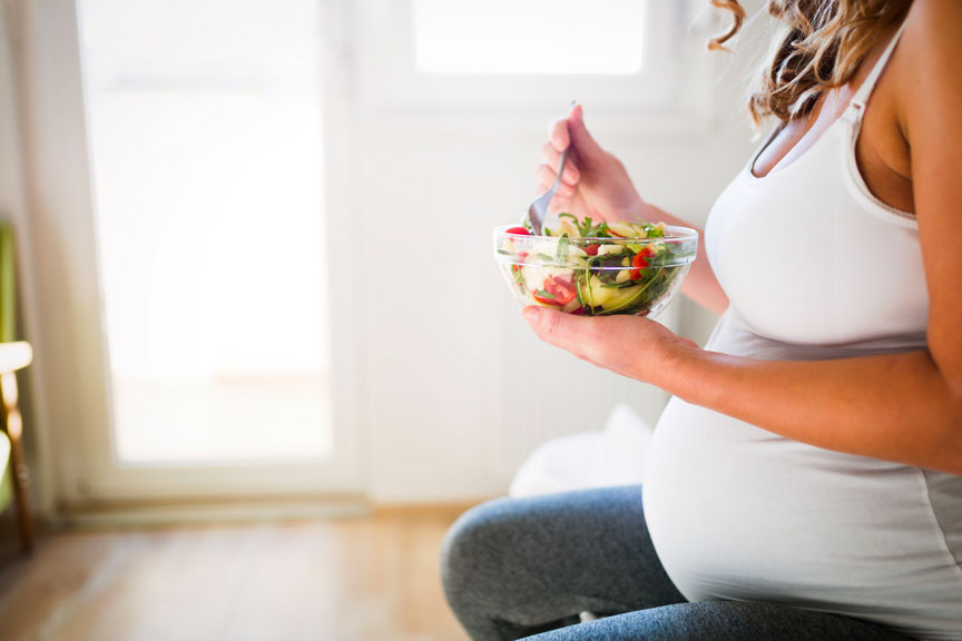 Pregnant woman eating healthy food