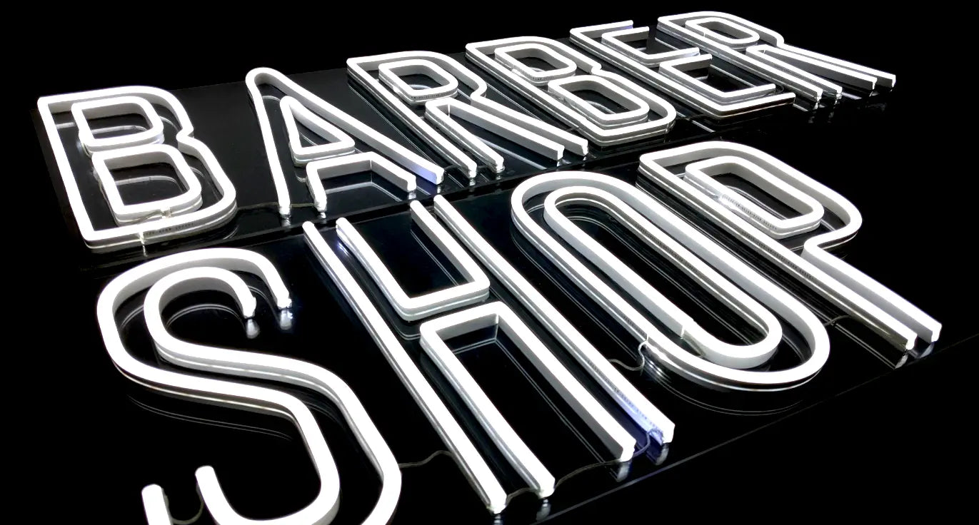 Vibrant LED Neon sign spelling 'Barber Shop' in luminous white, ideal for business advertising and storefront decoration