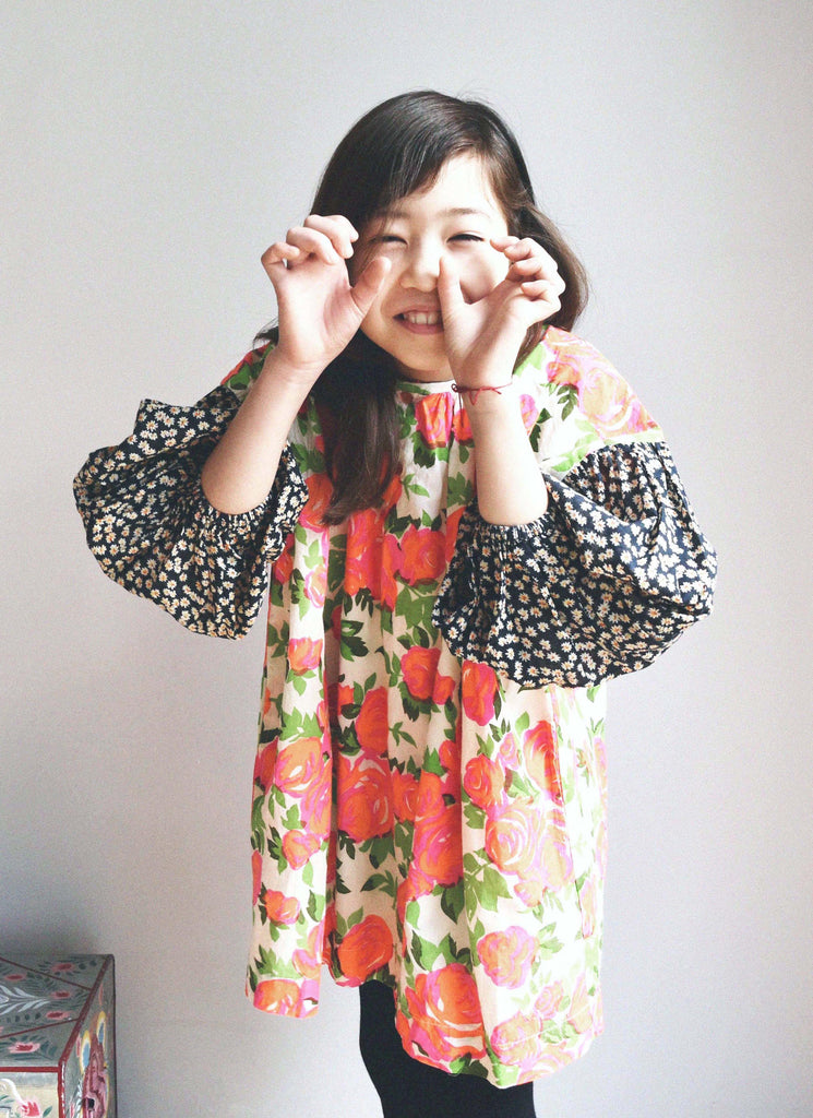 lulaland Fall No.15 Mirage collection. Girl wearing a flower dress. Organic girl's clothes