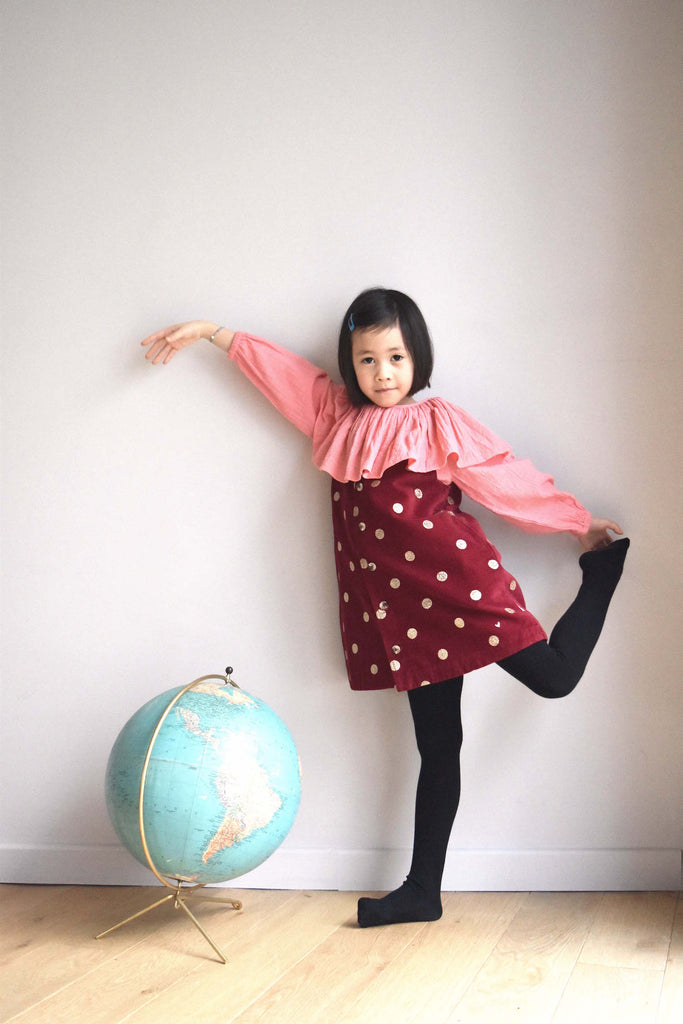 lulaland Fall No.15 Mirage collection. Girl wearing a pink blouse with collar and a red jumper with polka dots. Organic girl's clothes
