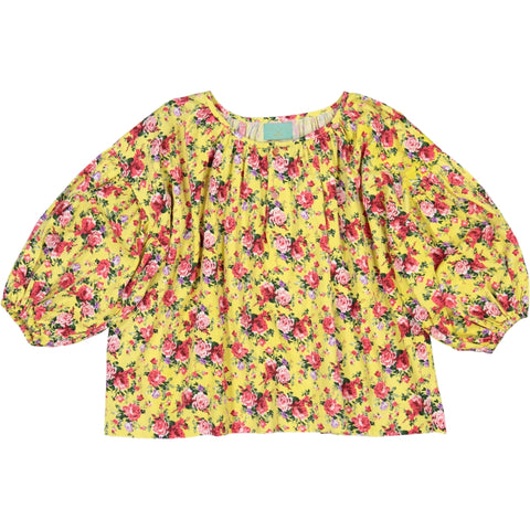 Girl's clothes. girl blouse in flower printed yellow fabric