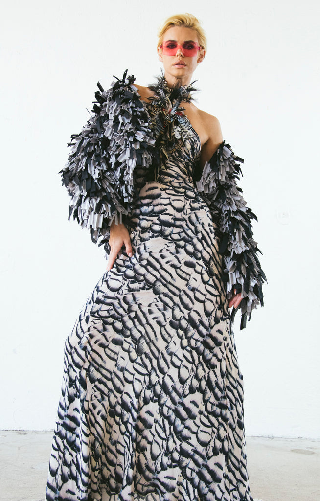 Preview photo of a Roberto Cavalli feather gown and Gianfranco Ferre mixed media jacket that will be in our booth at the show