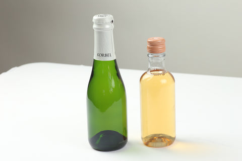 Two mini wine bottles ready for a new label