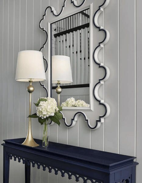 blue and white scalloped mirror on wall