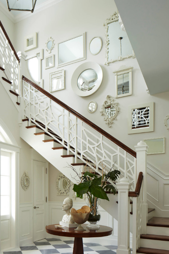 Gallery wall beside staircase by Whittmann Building Corp