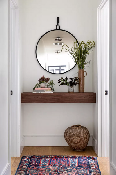 Small round wall mirror in hallway