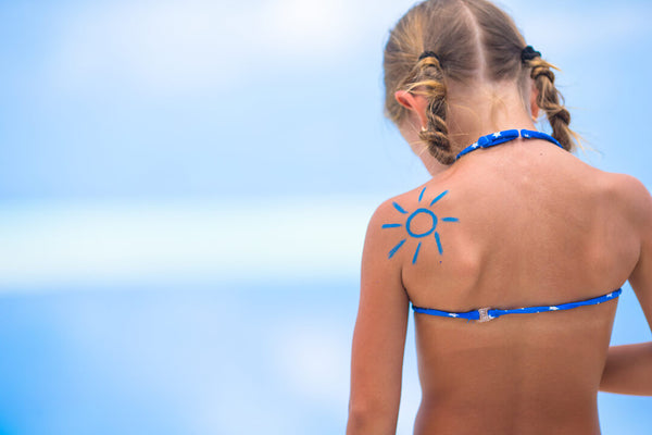 Girl with sun drawn on her back