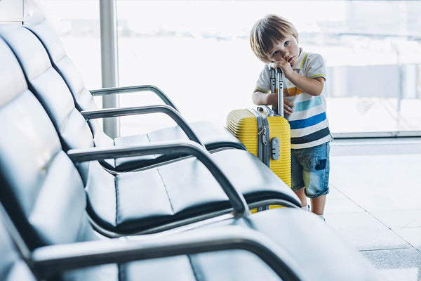 Boy with yellow suitcase