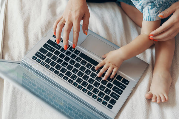 mom and baby working on laptop