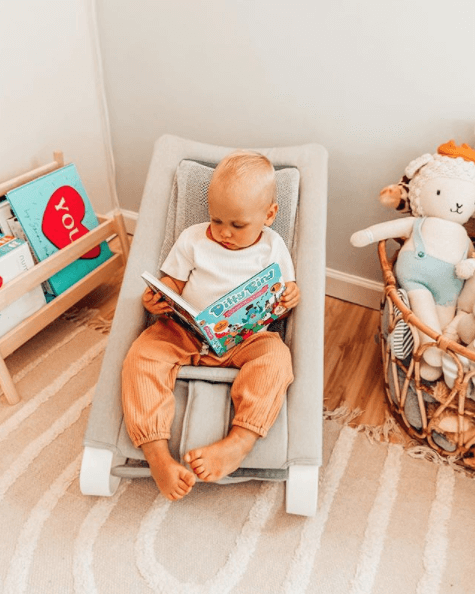 Boy reading in his Bouncer