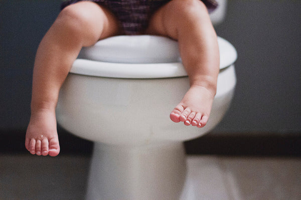 little legs dangling from the toilet