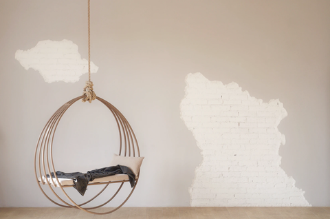 Hanging chair and neutral wall 