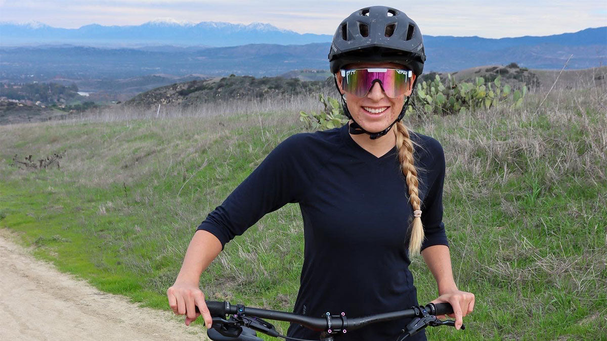Mountain Biker and Youtuber, Hannah The Kook, standing with her bike.