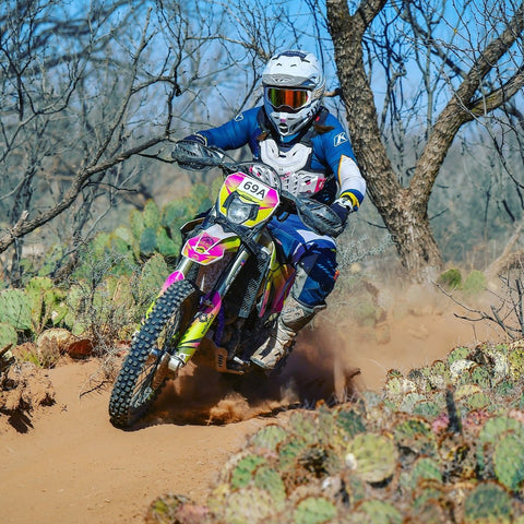 Jenny Burden riding a dirt bike during one of her races 