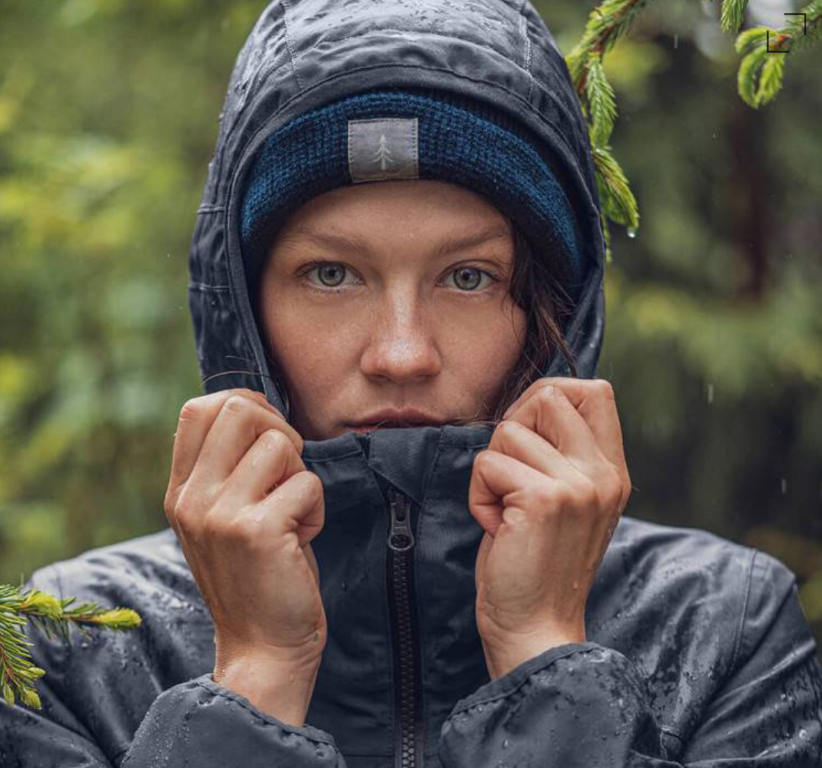 Woman in forest wearing a Bleed Clothing outdoor jacket