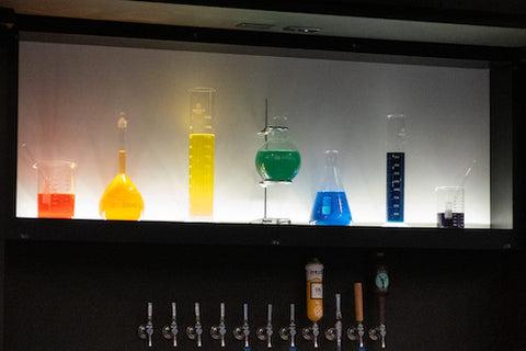 glass beakers filled with colorful liquids