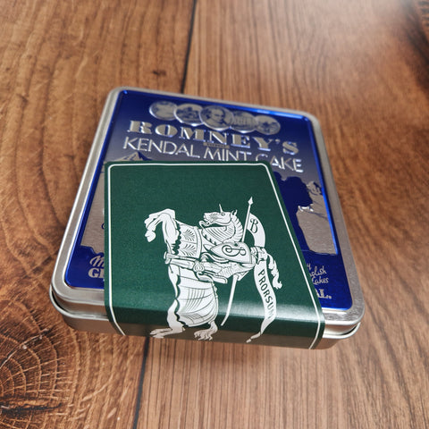 A Blue Romney's Kendal Mint Cake pocket tin featuring a Burberry label in Ivy Green, showcasing the Equestrian Knight Design.