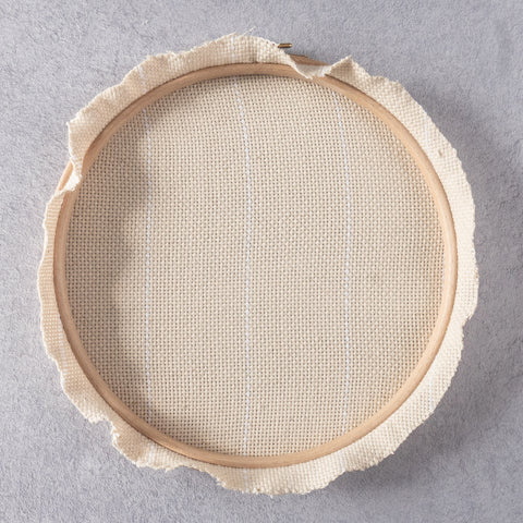Monks cloth fabric stretched in hoop and trimmed around edge