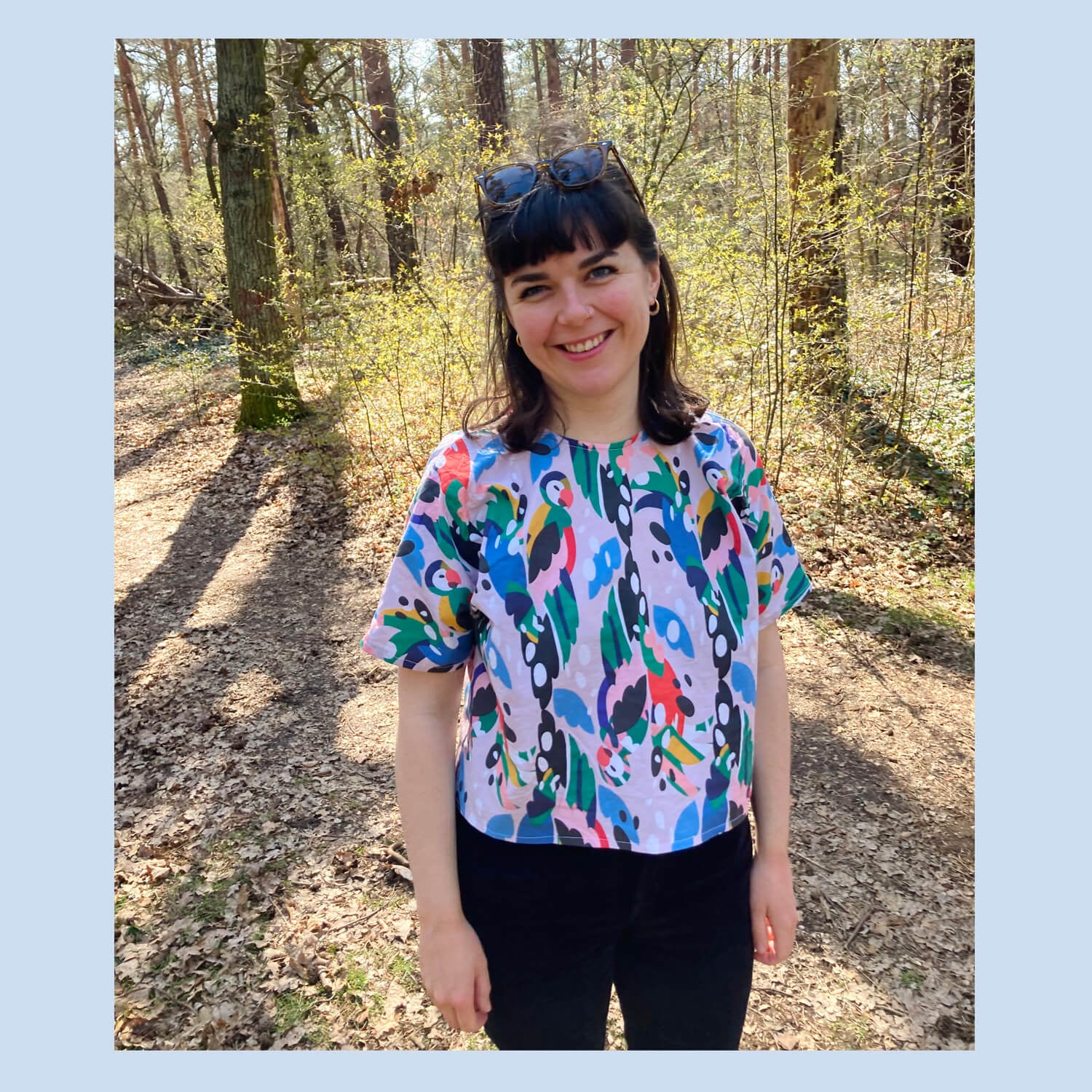 Alice wearing a handmade top in 'Find the Parrots' design