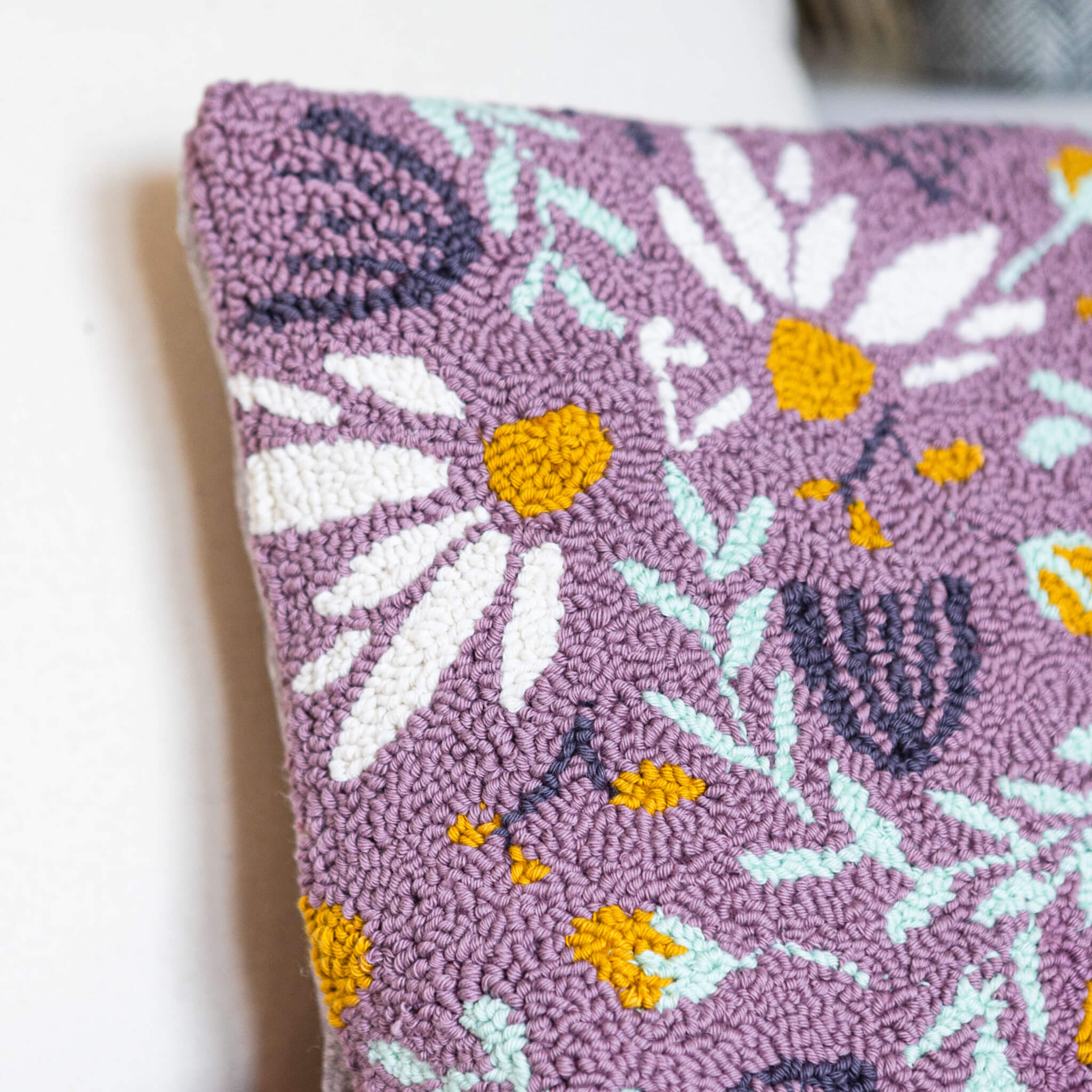 Close up of the lilac cotton floral punch needle cushion