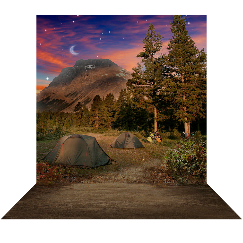 Camping Photo Backdrop features a beautiful campsite among the trees and mountains under a colorful moonlit sky