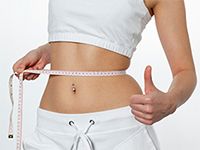 woman measuring her waist