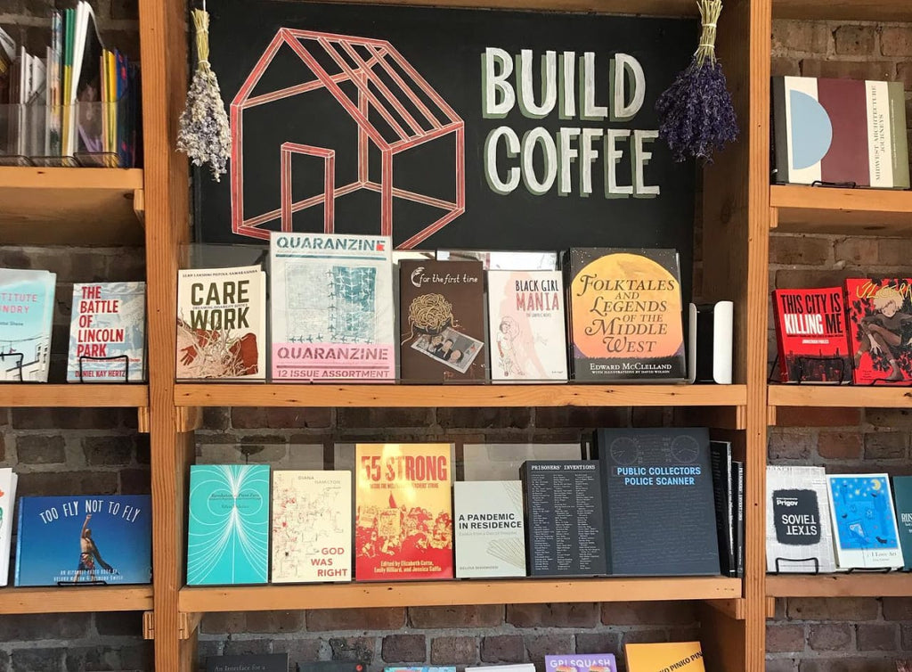 Photo of a book shelf with a sign that says, "Build Coffee."