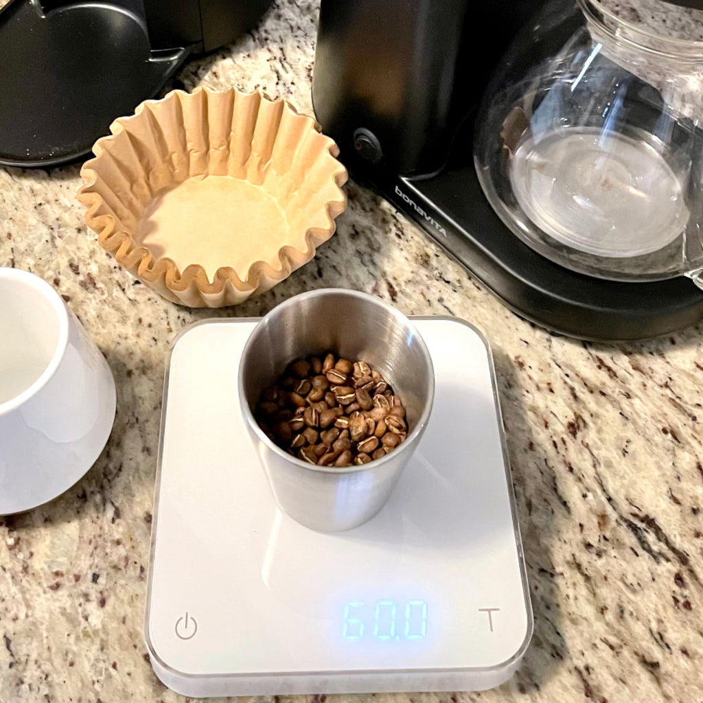 Photo of coffee beans being measured on a scale.