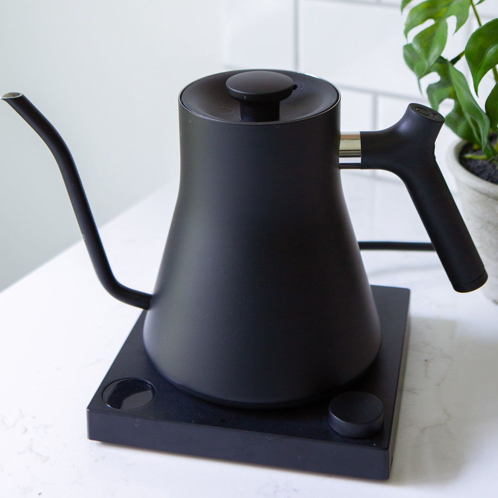 Photo of a gooseneck electric kettle on a kitchen counter.