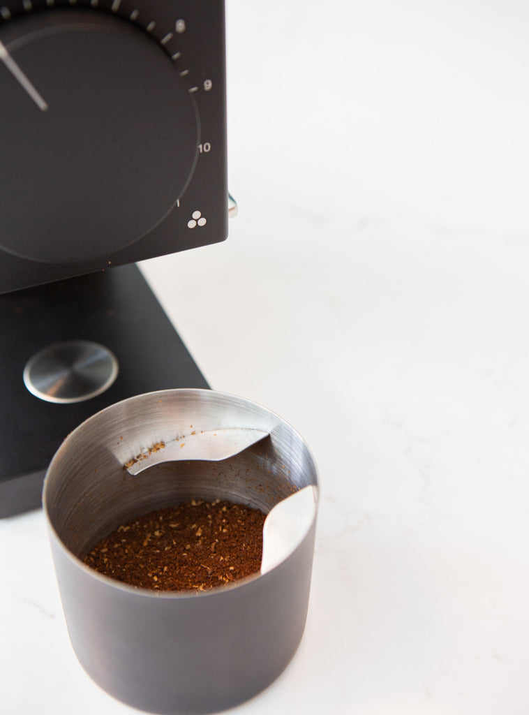 Ground coffee in the grinder cup.