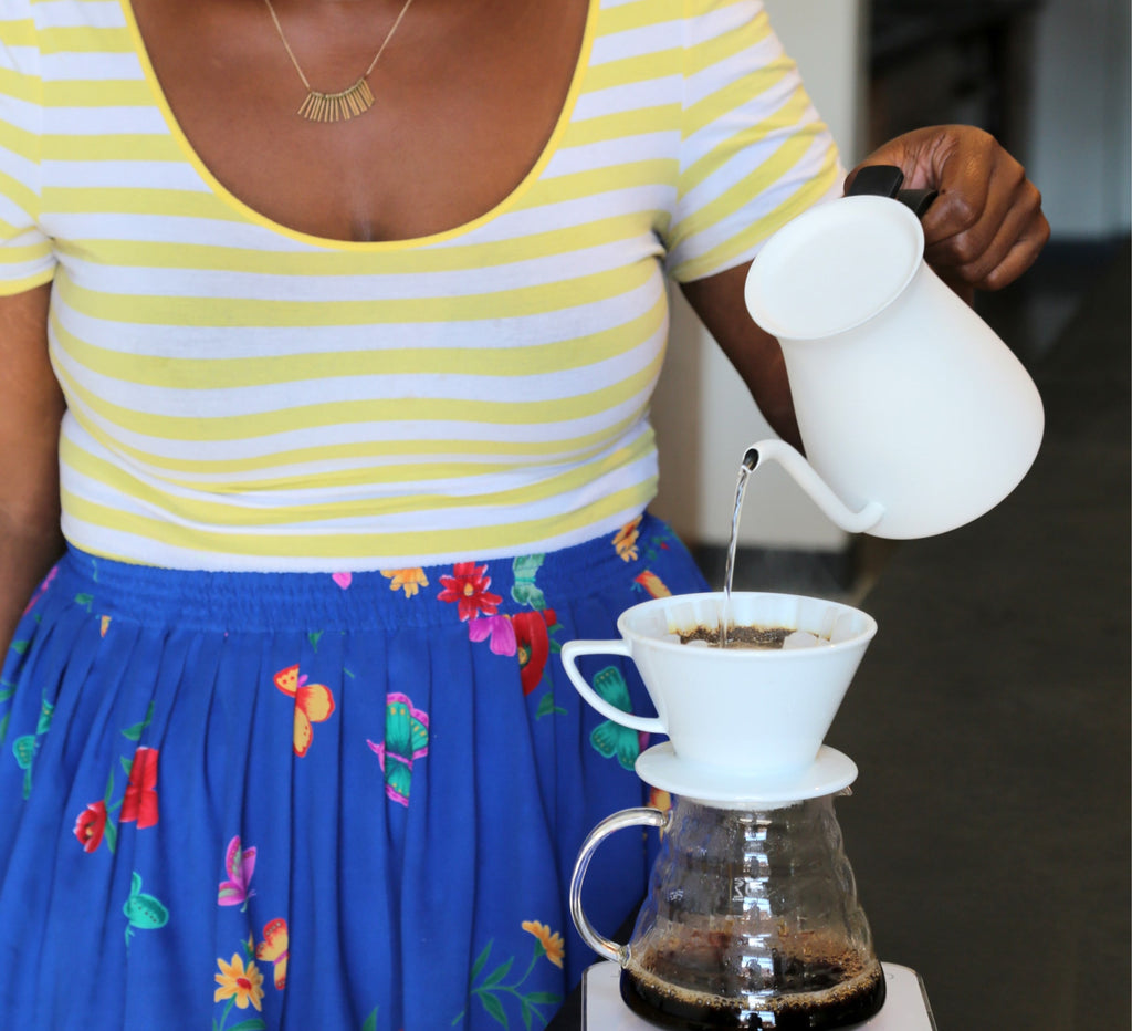 Photo of a person using a gooseneck kettle to make a pour-over.