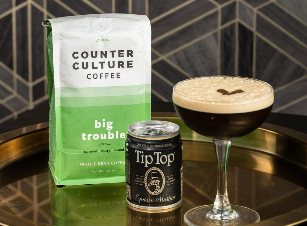 Photo of a bag of Big Trouble coffee, a can of Tip Top x Counter Culture espresso martini, and an espresso martini.