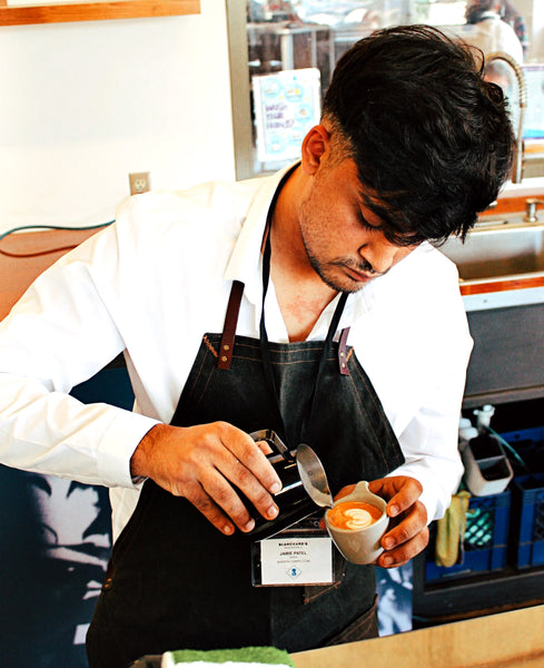 Photo of Jamie pouring latte art