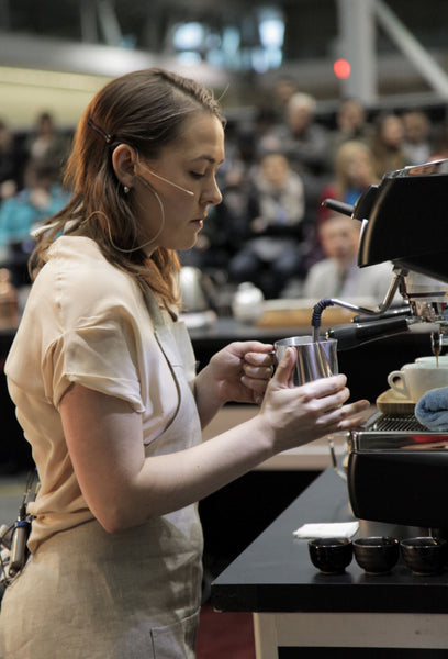 Photo of Katie Carguilo competing at the barista championships.