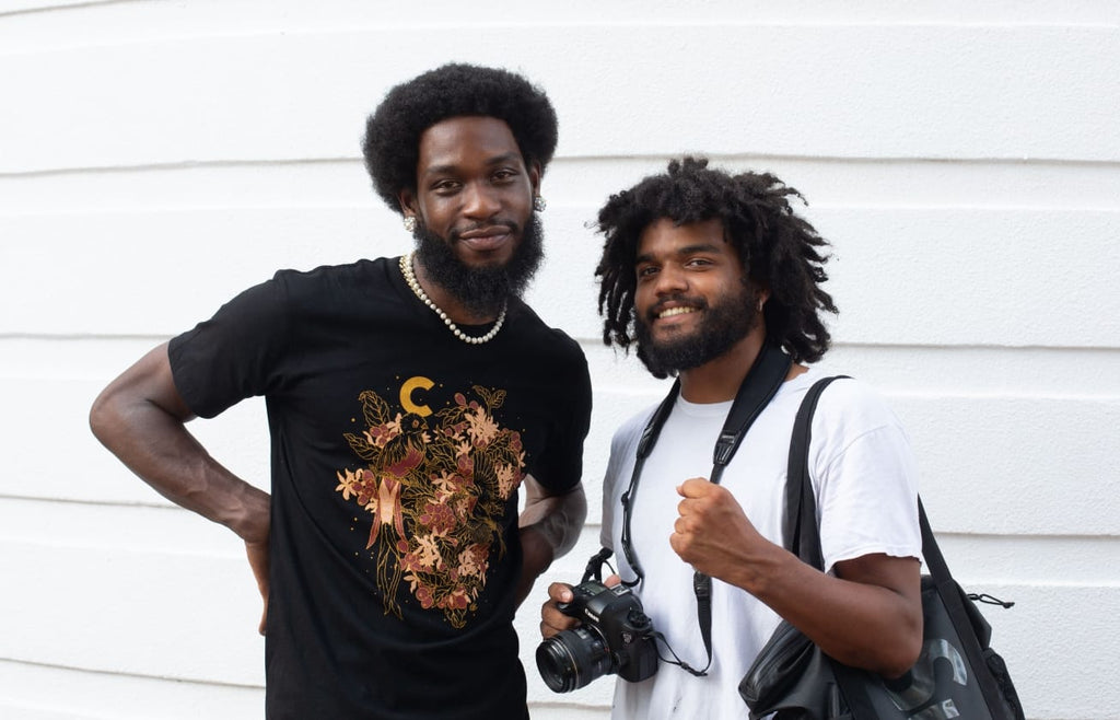 Photo of Godric and Tommy standing together and smiling at the camera.