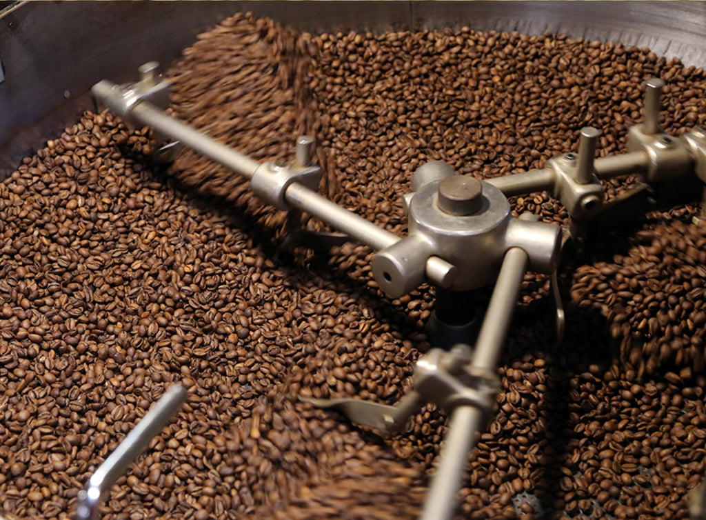 Photo of coffee being cooled in a drum after roasting.